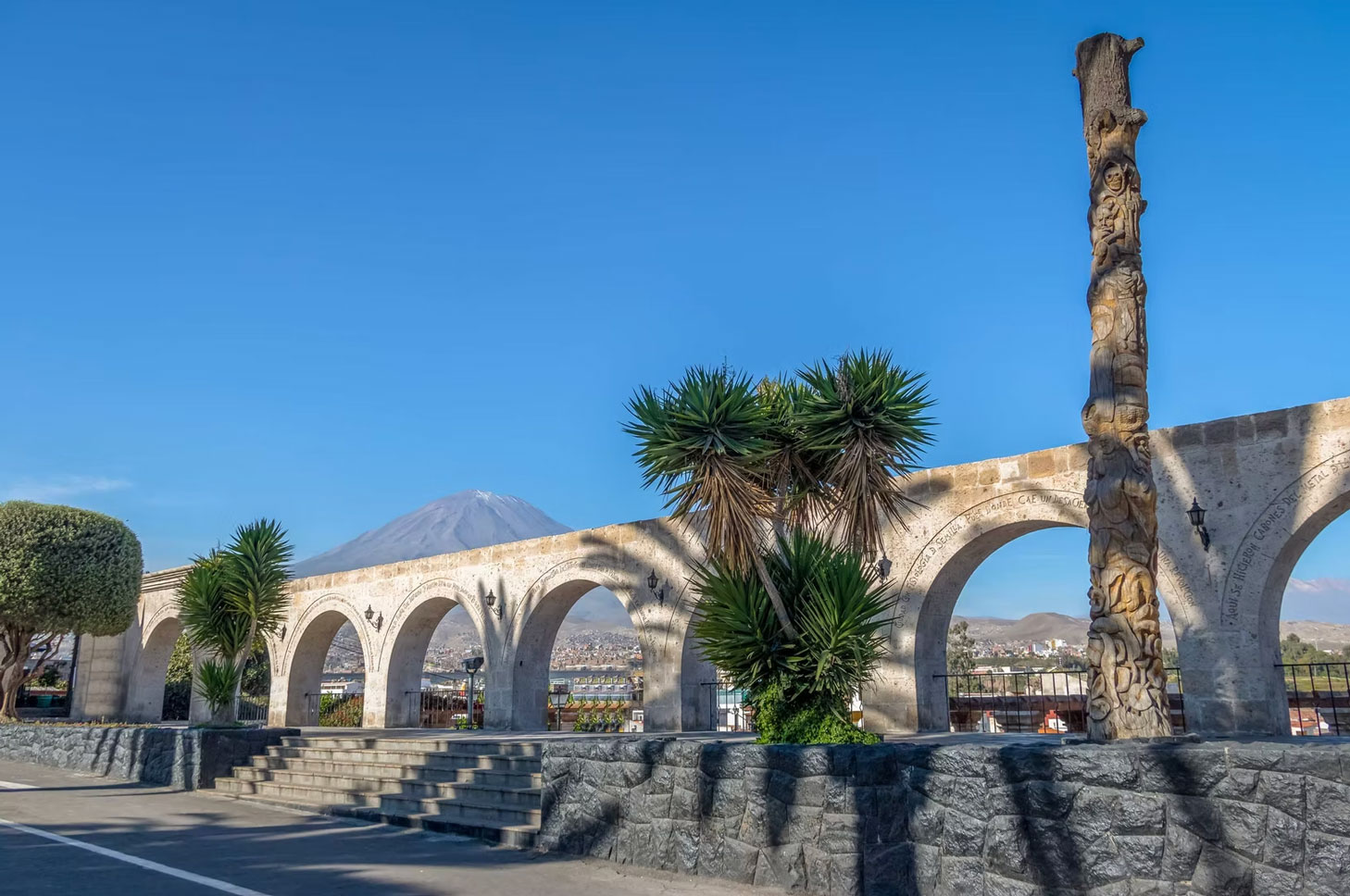 Colonial stone arches in Arequipa with the Misti volcano in the background