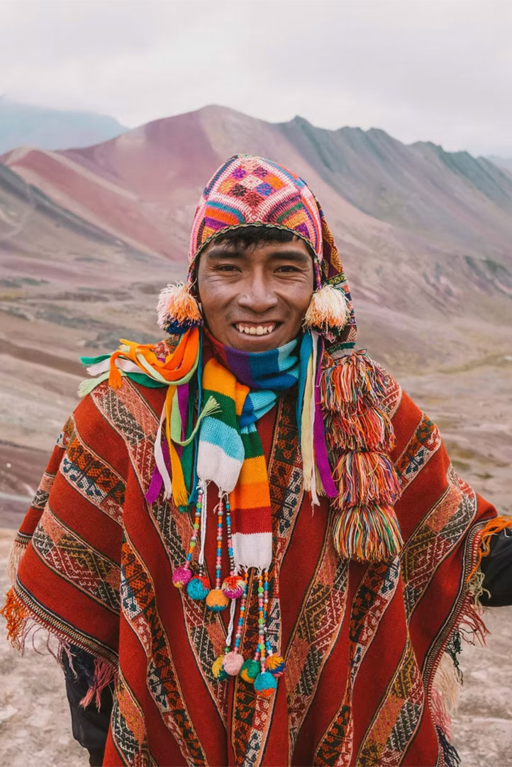 Local Andean man in traditional clothing at Palcoyo Rainbow Mountains