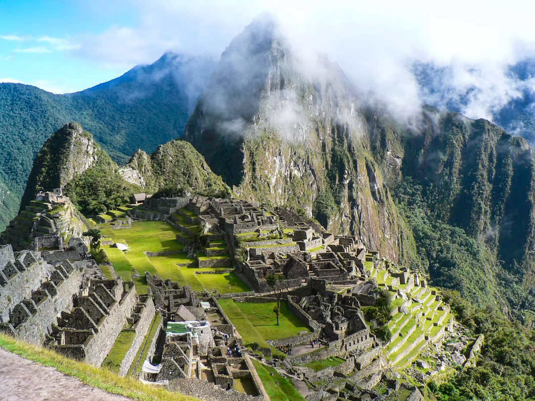 Machu Picchu ruins surrounded by mist and lush Andean mountains