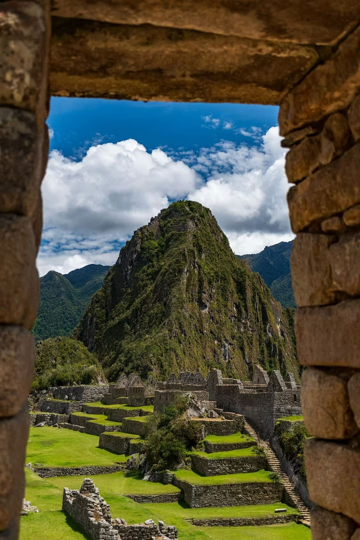 Machu Picchu viewed through a stone window, ancient Inca architecture
