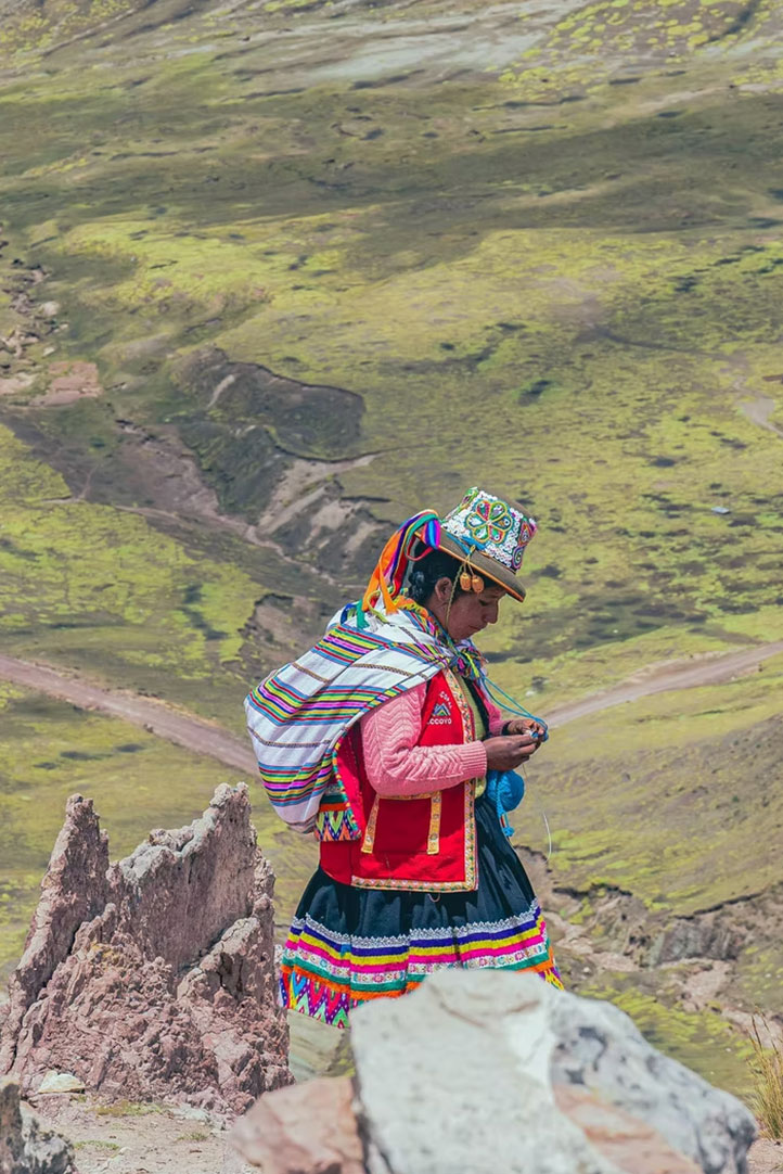 Andean woman walking through the Palcoyo highland landscape in Peru