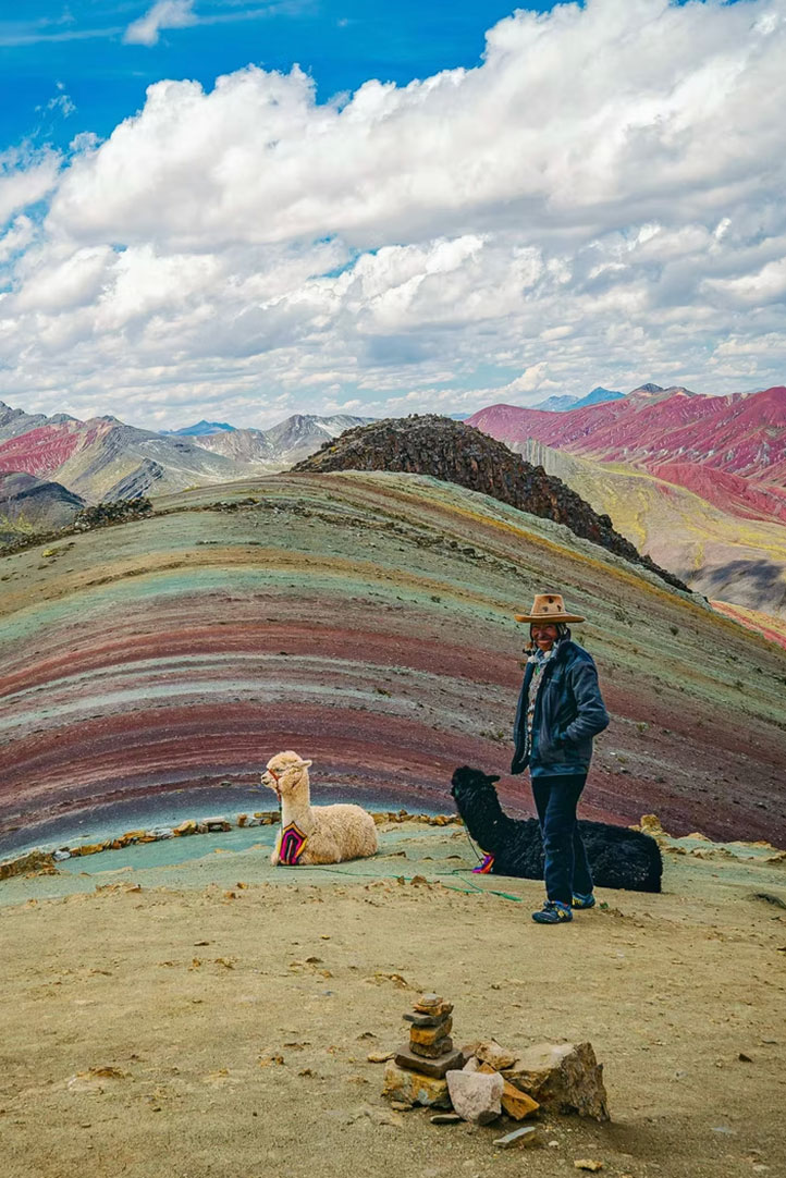 Andean shepherd with llamas at Palcoyo Rainbow Mountains in Peru