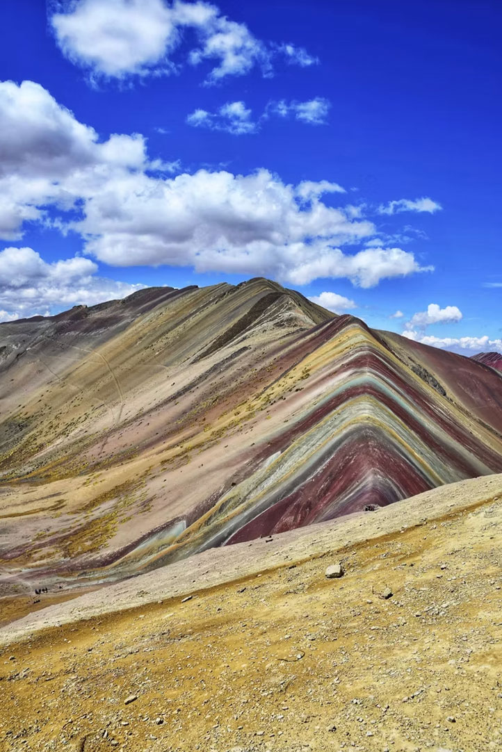 Panoramic view of Palcoyo Rainbow Mountains under a blue sky
