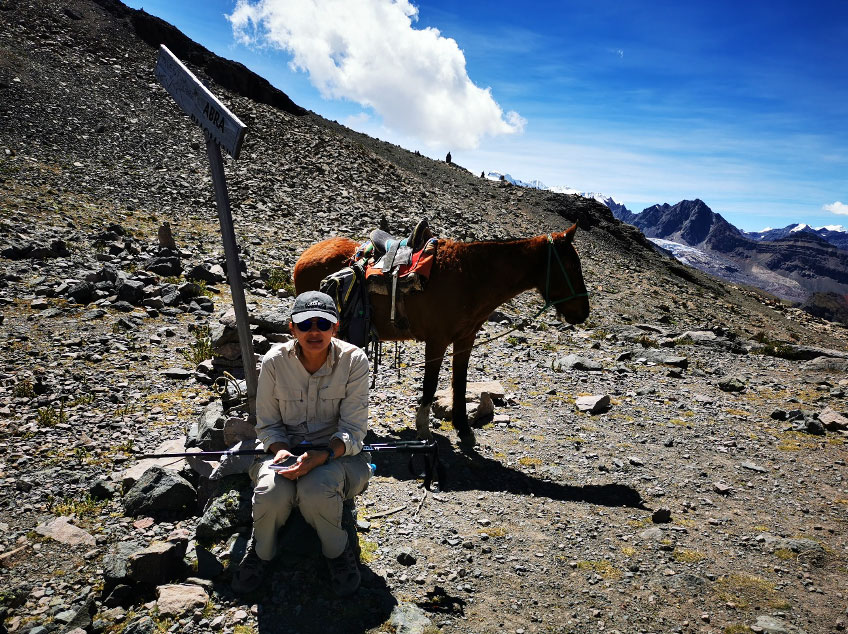 Trekker with a horse during the Ausangate high-altitude trek in Peru